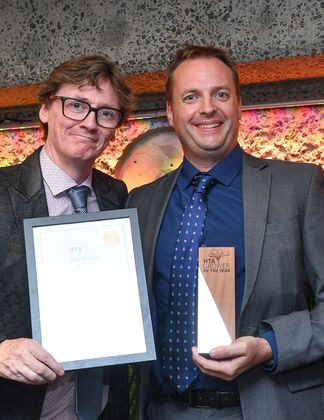 Left comedian and broadcaster Ed Byrne presenting Managing Director Charles James from Frank P Matthews.